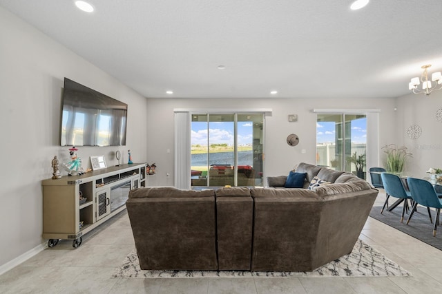 tiled living room featuring a healthy amount of sunlight and a chandelier