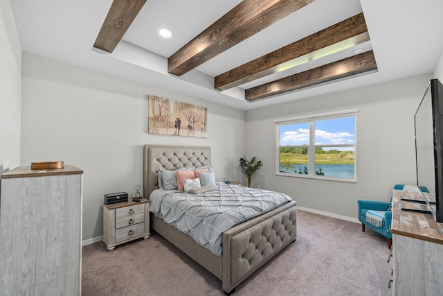 carpeted bedroom with beam ceiling