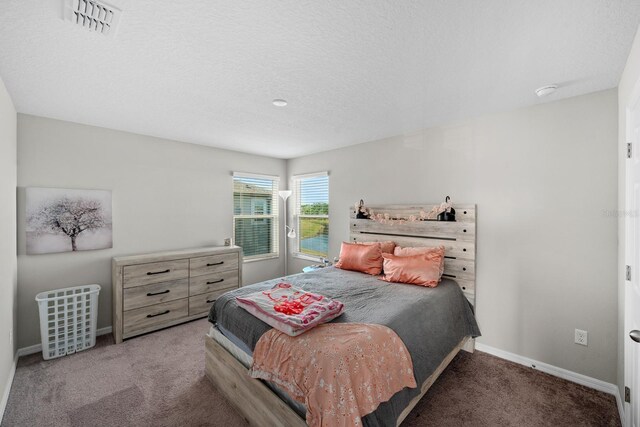 bedroom featuring carpet floors and a textured ceiling