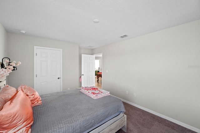 carpeted bedroom with a textured ceiling