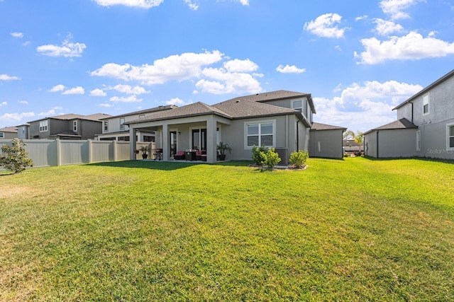 back of property featuring a yard, central AC unit, and a patio area