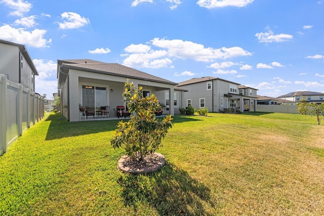 rear view of property with a lawn