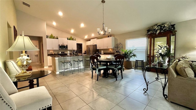 10854 Sage Canyon Dr, Riverview, FL 33578 - dining room featuring light tile patterned floors, visible vents, a chandelier, and high vaulted ceiling