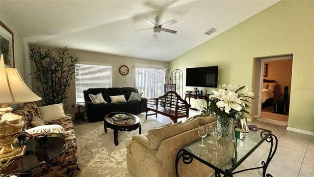 10854 Sage Canyon Dr, Riverview, FL 33578 - living area with light tile patterned floors, visible vents, baseboards, vaulted ceiling, and a ceiling fan