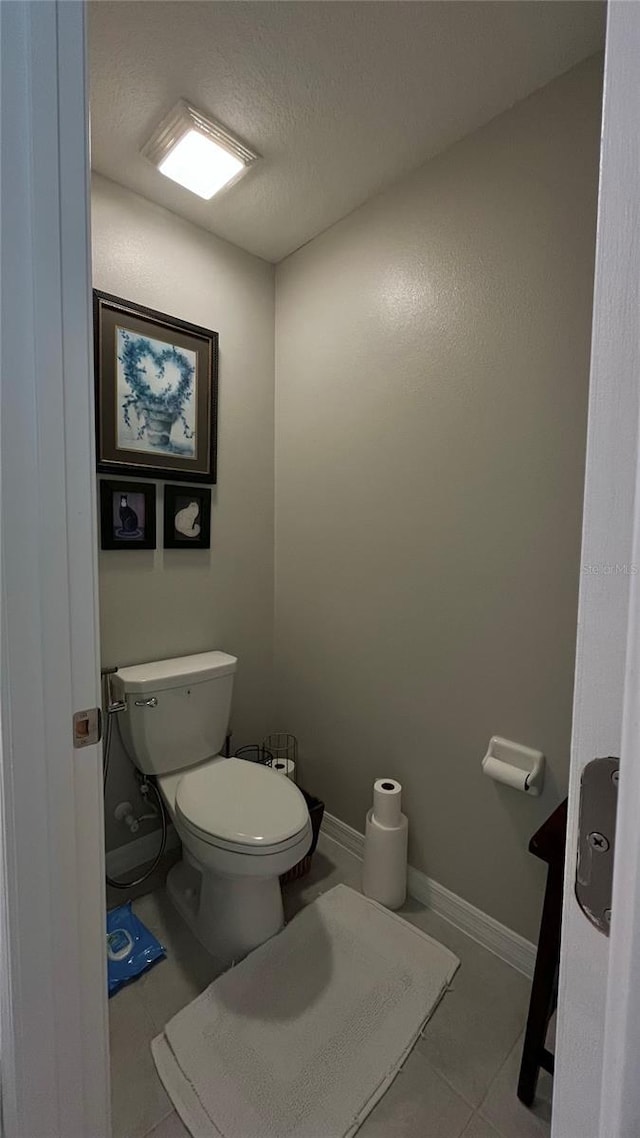 10854 Sage Canyon Dr, Riverview, FL 33578 - bathroom with tile patterned flooring, toilet, and baseboards