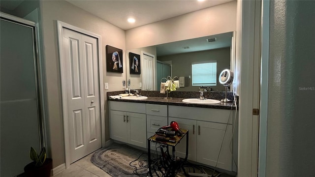 10854 Sage Canyon Dr, Riverview, FL 33578 - bathroom featuring double vanity, visible vents, a sink, and tile patterned floors