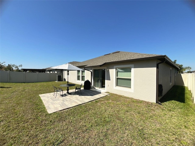 10854 Sage Canyon Dr, Riverview, FL 33578 - rear view of property with a patio, a fenced backyard, a shingled roof, a yard, and stucco siding