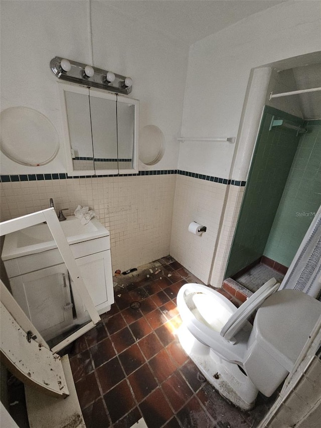 bathroom with toilet and tile walls