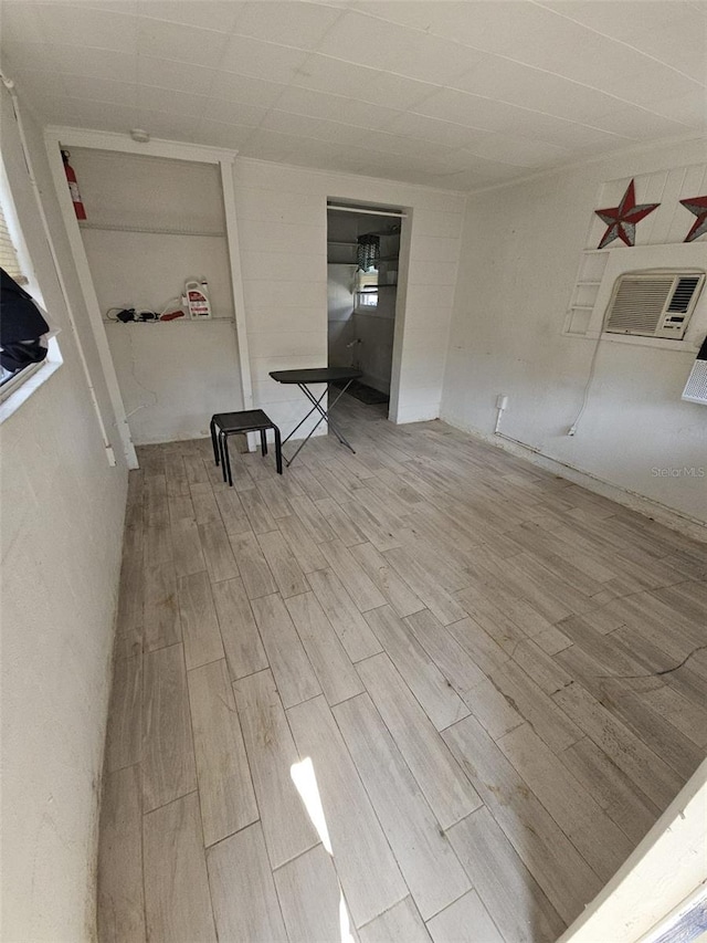 unfurnished room featuring wood-type flooring and a wall mounted AC