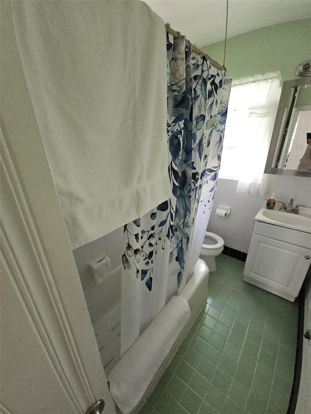 full bathroom with toilet, tile walls, vanity, shower / bath combination with curtain, and tile patterned flooring