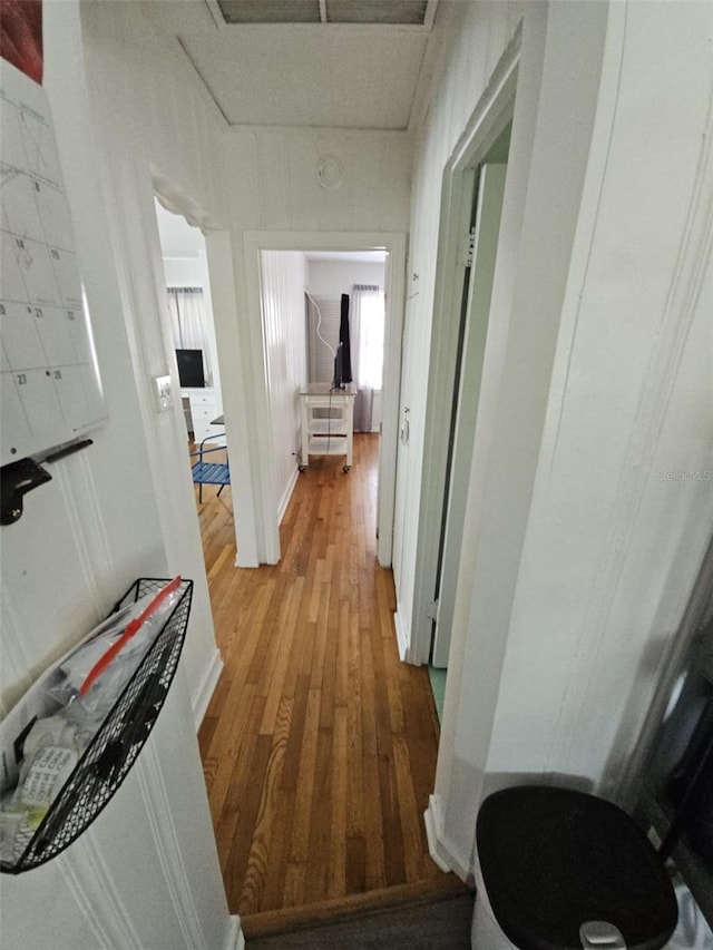 corridor with light hardwood / wood-style flooring