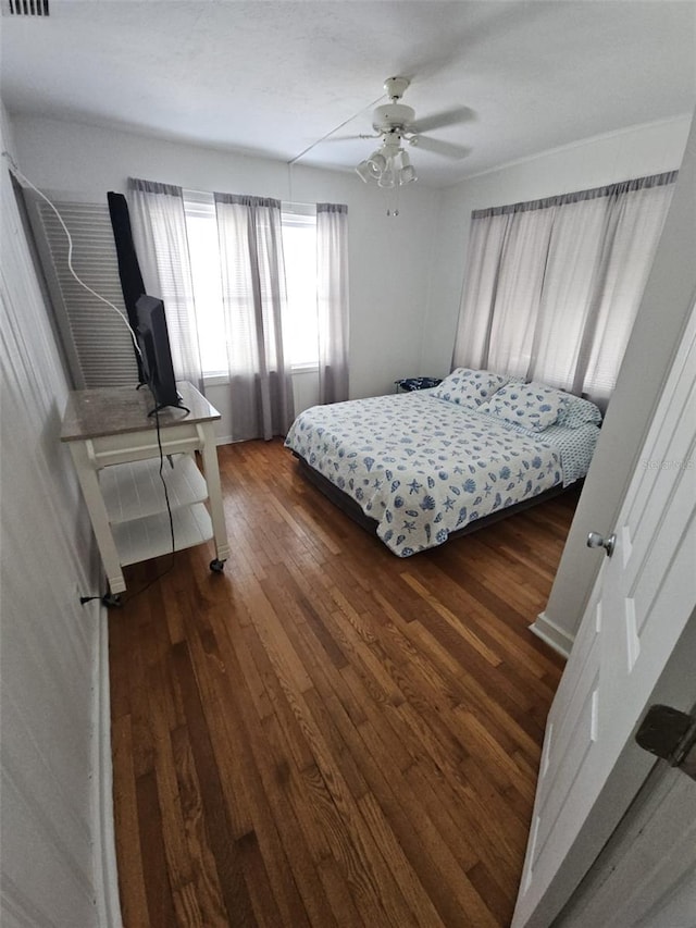 bedroom featuring ceiling fan and dark hardwood / wood-style floors