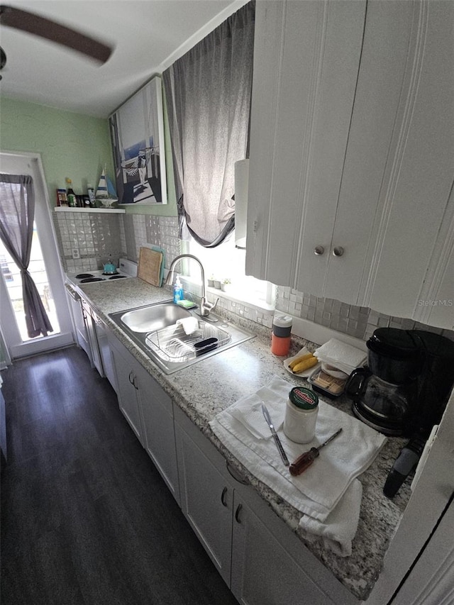 kitchen featuring sink, backsplash, dark hardwood / wood-style floors, and white cabinets