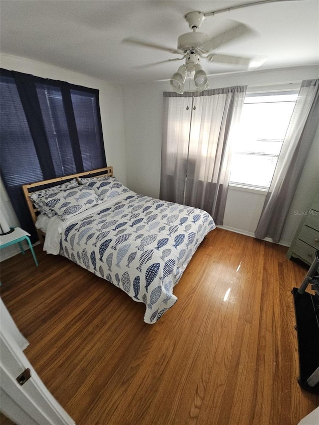 bedroom with wood-type flooring and ceiling fan