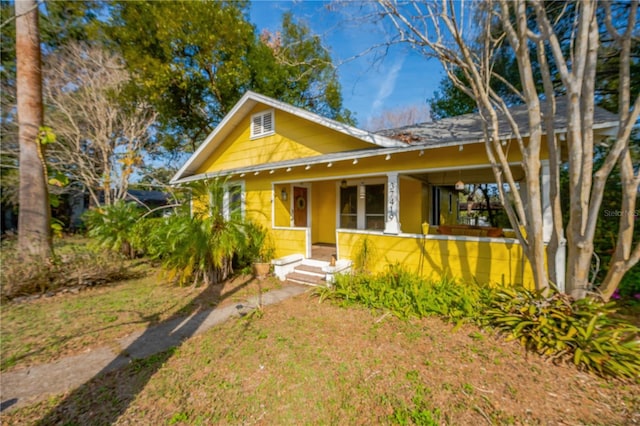 bungalow-style home with a front lawn