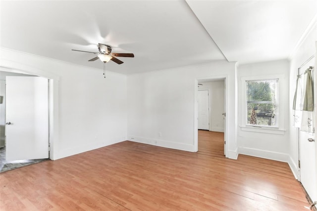 empty room featuring crown molding, ceiling fan, and light hardwood / wood-style flooring