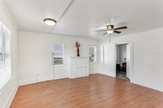 unfurnished room featuring cooling unit, ceiling fan, ornamental molding, and light hardwood / wood-style floors