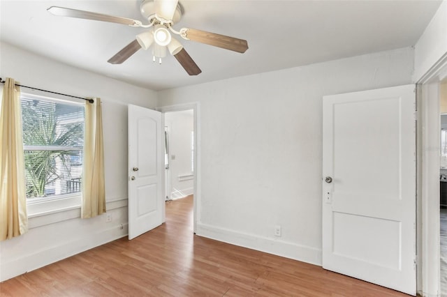 unfurnished bedroom with ceiling fan and light wood-type flooring