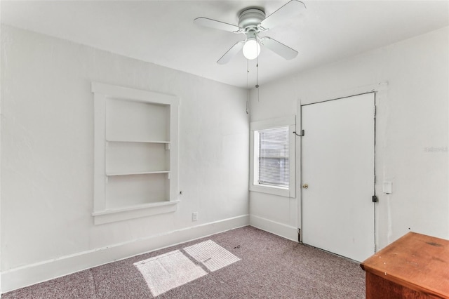 spare room featuring ceiling fan and carpet flooring