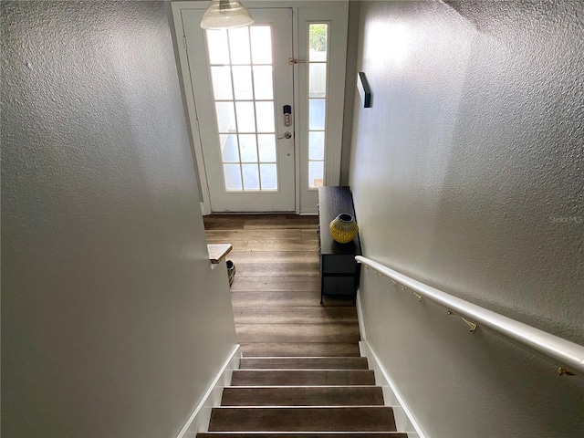 stairs featuring hardwood / wood-style floors