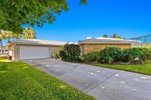 ranch-style home with a garage and a front yard