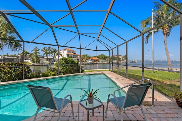 view of swimming pool featuring a water view, a patio area, and a lanai