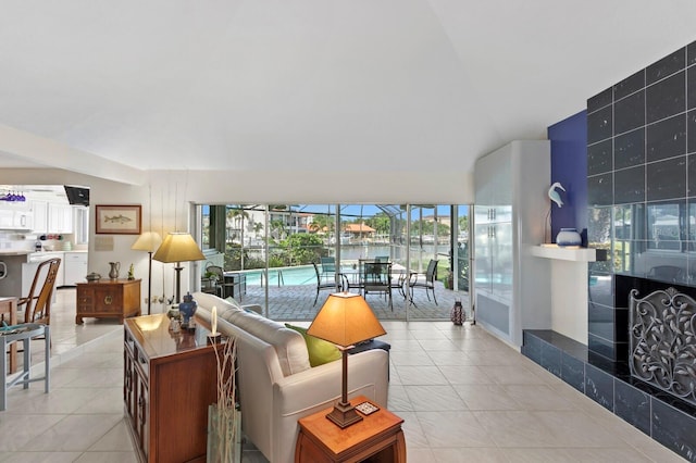 living room featuring light tile patterned floors, a fireplace, and floor to ceiling windows