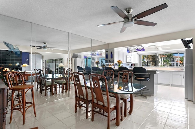 dining room with light tile patterned floors and a textured ceiling