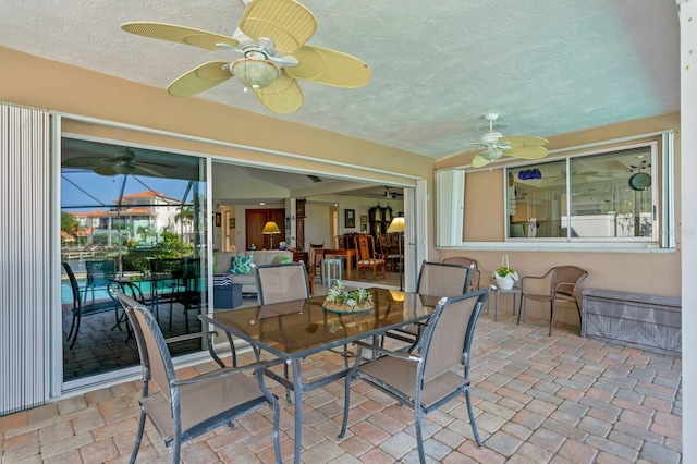 sunroom featuring ceiling fan