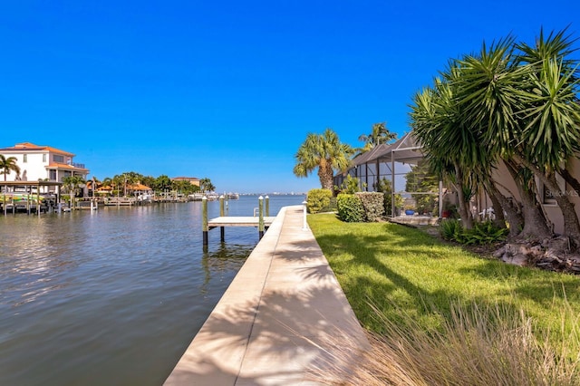 view of dock featuring a yard, a lanai, and a water view