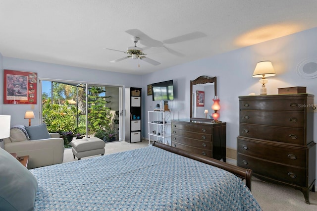 bedroom with light carpet, access to exterior, and ceiling fan