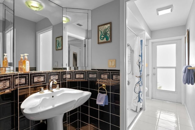 bathroom featuring tile walls, sink, tile patterned flooring, and walk in shower