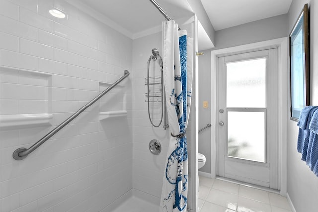 bathroom with a shower with curtain, tile patterned floors, and toilet