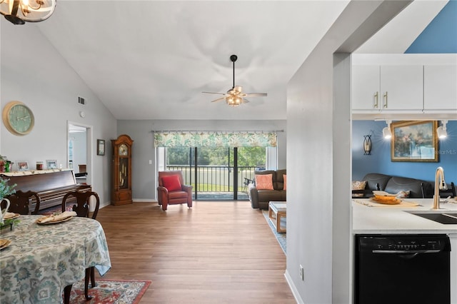 living room featuring ceiling fan, high vaulted ceiling, sink, and light hardwood / wood-style floors