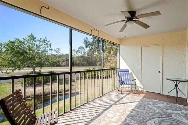 sunroom / solarium featuring ceiling fan