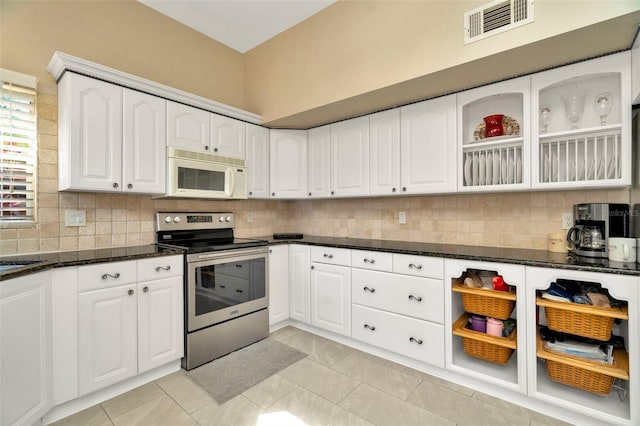 kitchen with tasteful backsplash, dark stone countertops, white cabinets, and stainless steel electric range oven