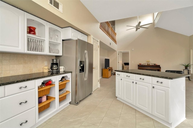 kitchen with ceiling fan, dark stone countertops, stainless steel fridge with ice dispenser, and white cabinets