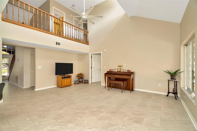 living room featuring ceiling fan and high vaulted ceiling