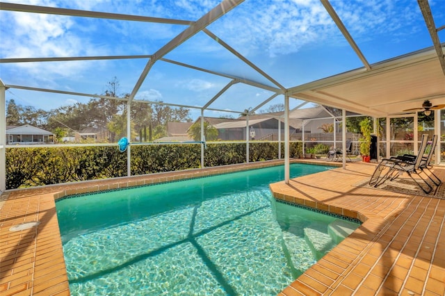 view of swimming pool featuring a patio and glass enclosure