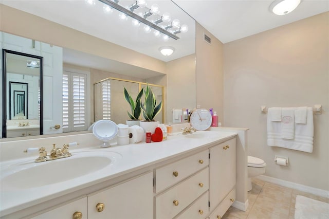 bathroom featuring vanity, toilet, an enclosed shower, and tile patterned flooring