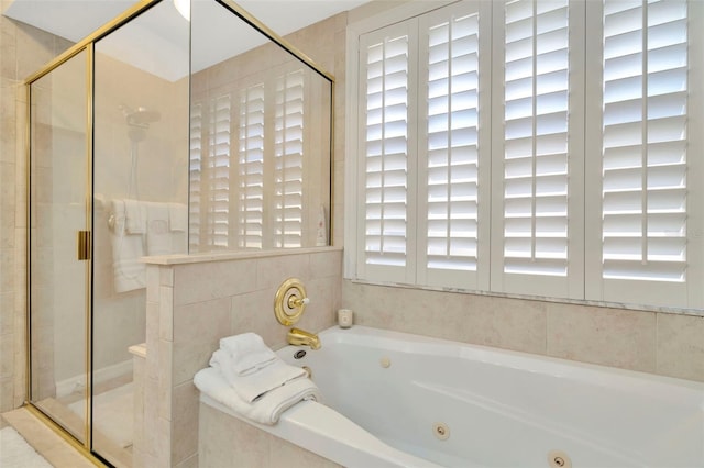 bathroom featuring separate shower and tub