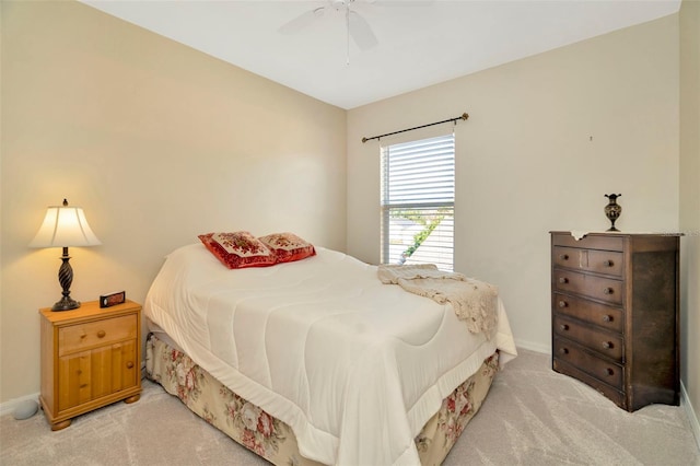 bedroom with light carpet and ceiling fan