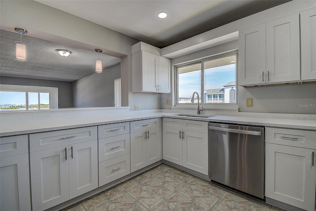 kitchen with sink, a wealth of natural light, white cabinets, decorative light fixtures, and stainless steel dishwasher