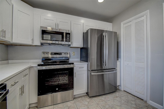 kitchen with appliances with stainless steel finishes and white cabinets