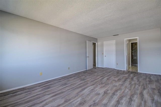 interior space with hardwood / wood-style flooring and a textured ceiling