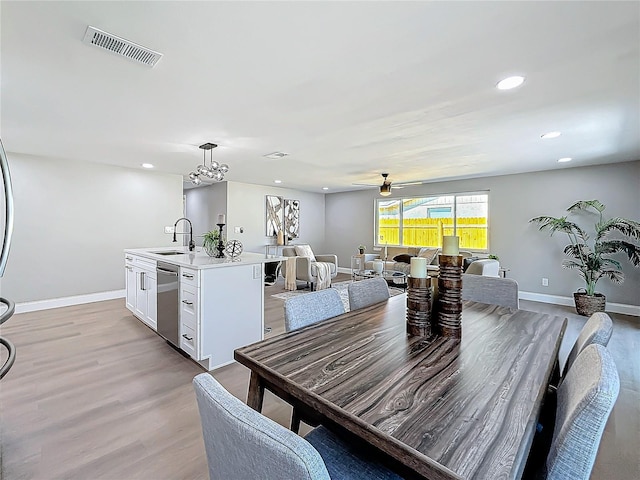 dining area featuring sink, light hardwood / wood-style flooring, and ceiling fan