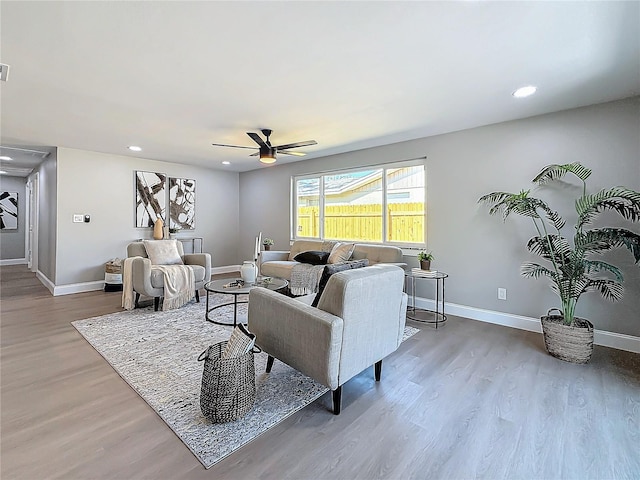 living room with ceiling fan and hardwood / wood-style floors