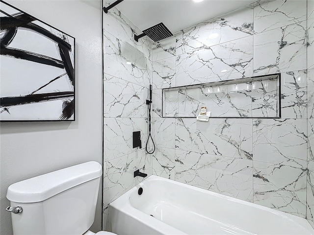 bathroom featuring tiled shower / bath and toilet