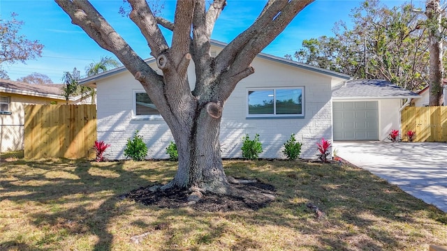 view of front of home with a garage and a front lawn