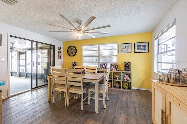 dining area with dark wood-type flooring, a textured ceiling, and ceiling fan